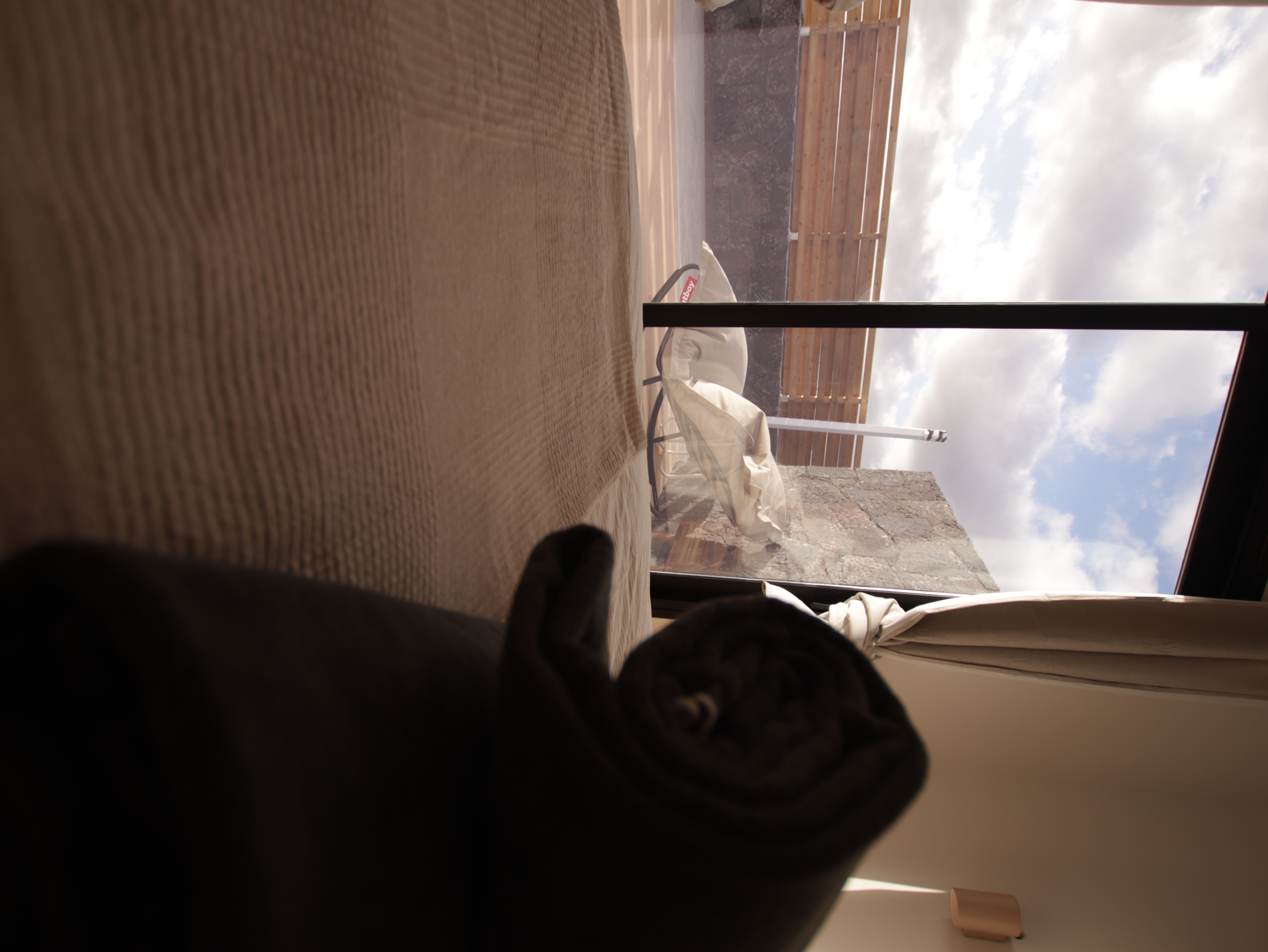 Bedroom with linen bedding and wooden details