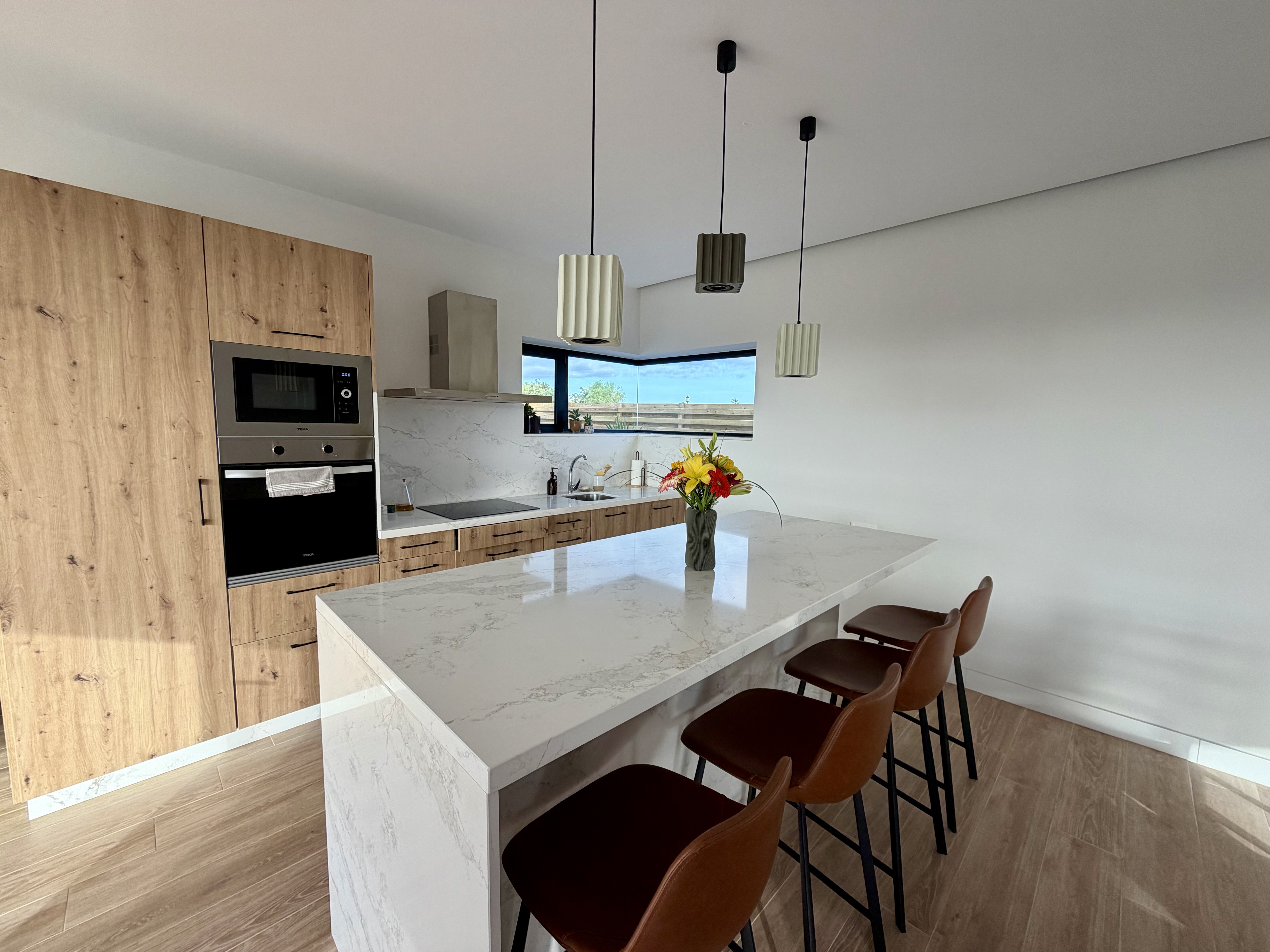 Open kitchen with wooden cabinetry and shelving