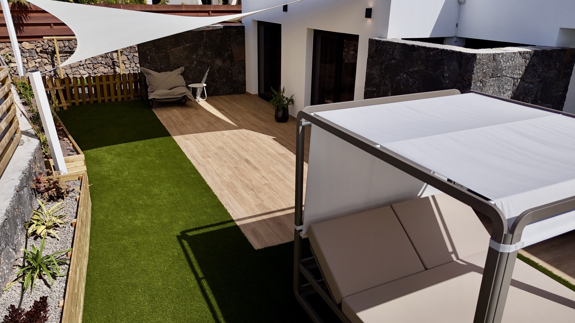 Bird's eye view of heated pool, jacuzzi and outdoor lounge at Elements Lajares